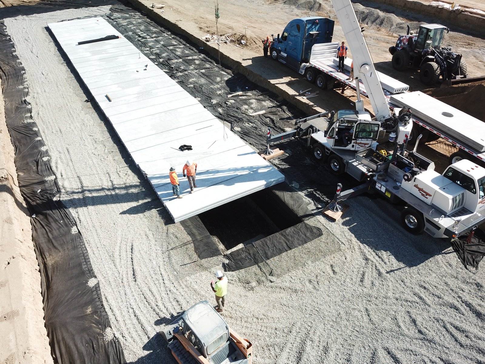 A crane placing precast roof planks over the Montclair GeoStorage system